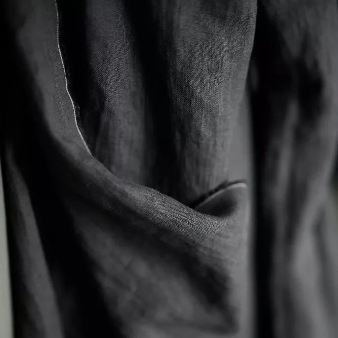 Merchant and Mills European Laundered Linen 185 in Scuttle Black Australia Stitch Piece Loop. The image is of the fabric draped over the roll.