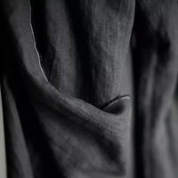 Merchant and Mills European Laundered Linen 185 in Scuttle Black Australia Stitch Piece Loop. The image is of the fabric draped over the roll.