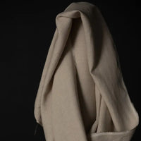 Merchant & Mills 185 European Laundered Linen in Big Sur. A natural coloured dressmaking weight linen. Image is of the cloth draped over the roll.
