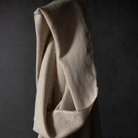 Merchant & Mills 185 European Laundered Linen in Big Sur. A natural coloured dressmaking weight linen. Image is of the cloth draped over the roll.