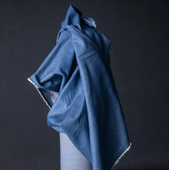 Merchant and Mills 8oz Washed Cotton Denim in Medium. Fabric is draped over bolt.