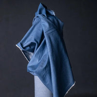 Merchant and Mills 8oz Washed Cotton Denim in Medium. Fabric is draped over bolt.