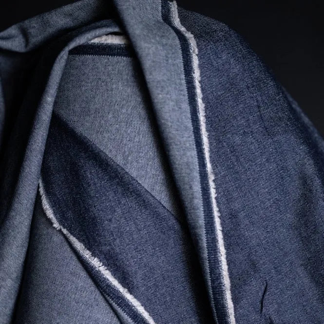 Merchant and Mills 8oz Washed Denim in Dark. The fabric is draped over the roll. 