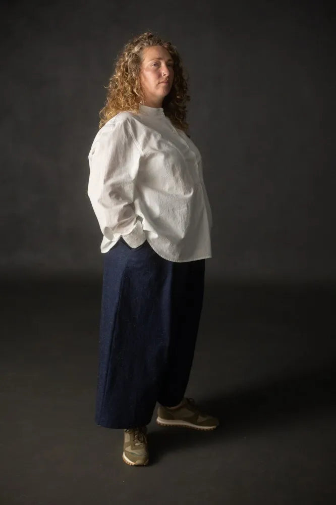 Person wearing a navy pair of Juno Trousers against a dark background. The Juno Trouser sewing pattern is by Merchant and Mills, and available at Stitch Piece Loop, Australia.
