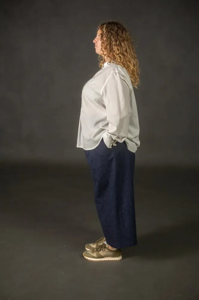 Person wearing a navy pair of Juno Trousers against a dark background. The Juno Trouser sewing pattern is by Merchant and Mills, and available at Stitch Piece Loop, Australia.
