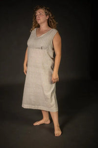 Woman wearing a beige stripe Lilian Slip dress. The Lilian Slip Dress Sewing Pattern by Merchant and Mills available at Stitch Piece Loop Australia