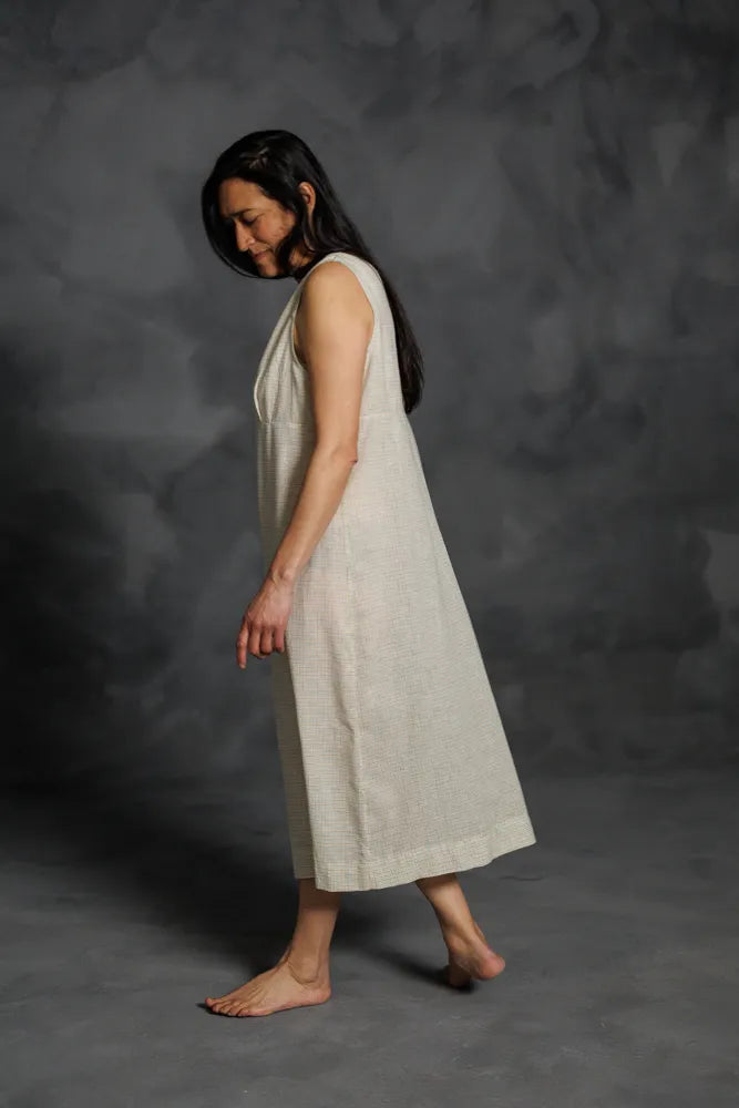 Woman wearing a beige Lilian Slip dress. The Lilian Slip Dress Sewing Pattern by Merchant and Mills available at Stitch Piece Loop Australia