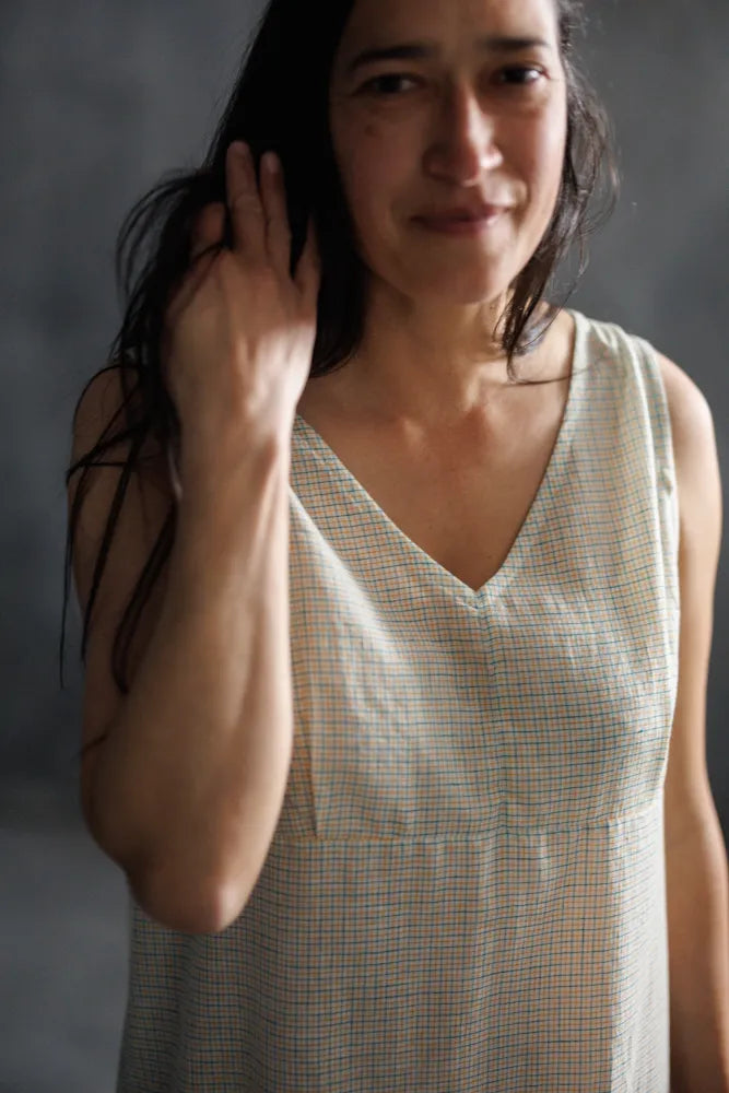 Woman wearing a beige Lilian Slip dress. The Lilian Slip Dress Sewing Pattern by Merchant and Mills available at Stitch Piece Loop Australia