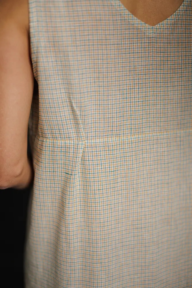 Close up of a beige check Lilian Slip dress showing pin tuck detail. The Lilian Slip Dress Sewing Pattern by Merchant and Mills available at Stitch Piece Loop Australia