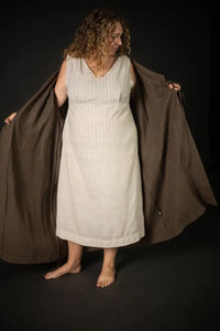 Woman wearing a beige stripe Lilian Slip dress. The Lilian Slip Dress Sewing Pattern by Merchant and Mills available at Stitch Piece Loop Australia