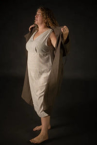 Woman wearing a beige stripe Lilian Slip dress. The Lilian Slip Dress Sewing Pattern by Merchant and Mills available at Stitch Piece Loop Australia