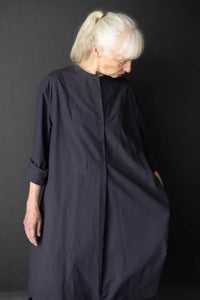 Woman wearing a dark blue Niven Shirt Dress. The Niven Shirt Dress Sewing Pattern by Merchant and Mills available at Stitch Piece Loop Australia.