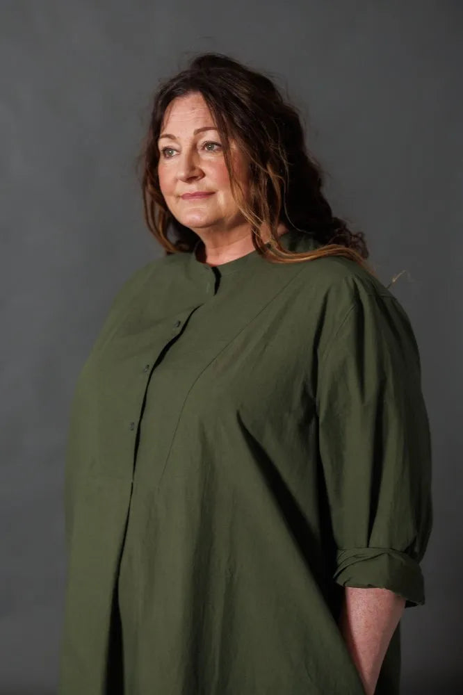 Woman wearing a dark green Niven Shirt Dress. The Niven Shirt Dress Sewing Pattern by Merchant and Mills available at Stitch Piece Loop Australia.