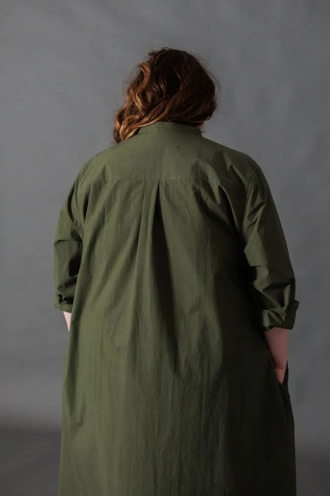 Woman wearing a dark green Niven Shirt Dress. The Niven Shirt Dress Sewing Pattern by Merchant and Mills available at Stitch Piece Loop Australia.