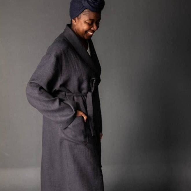 Merchant and Mills European Laundered Linen 185 in Scuttle Black Australia Stitch Piece Loop. The image is of a woman wearing a robe made out of the Scuttle Black linen.