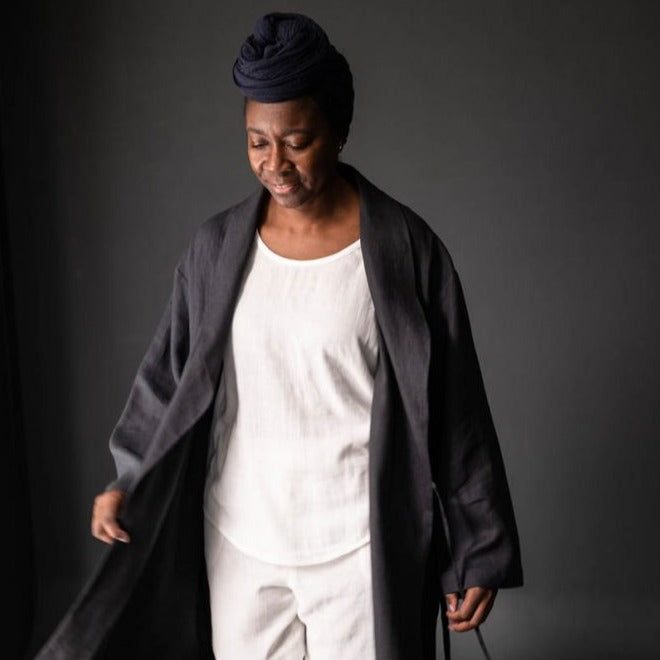 Merchant and Mills European Laundered Linen 185 in Scuttle Black Australia Stitch Piece Loop. The image is of a woman wearing a robe made out of the Scuttle Black linen.